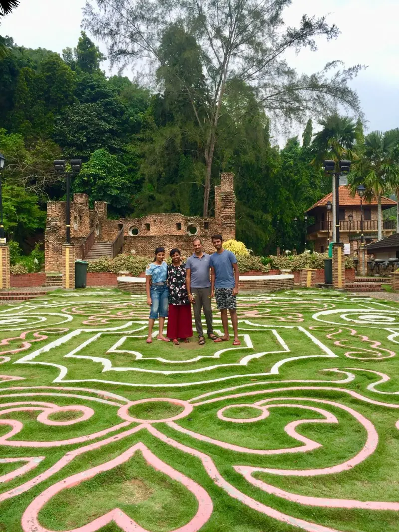 Visitors at heritage garden park with decorative labyrinth