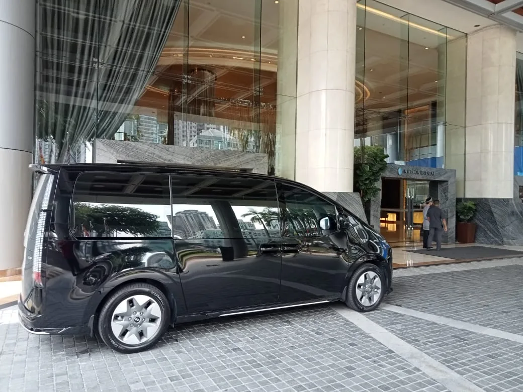 Group of four in van during night transfer