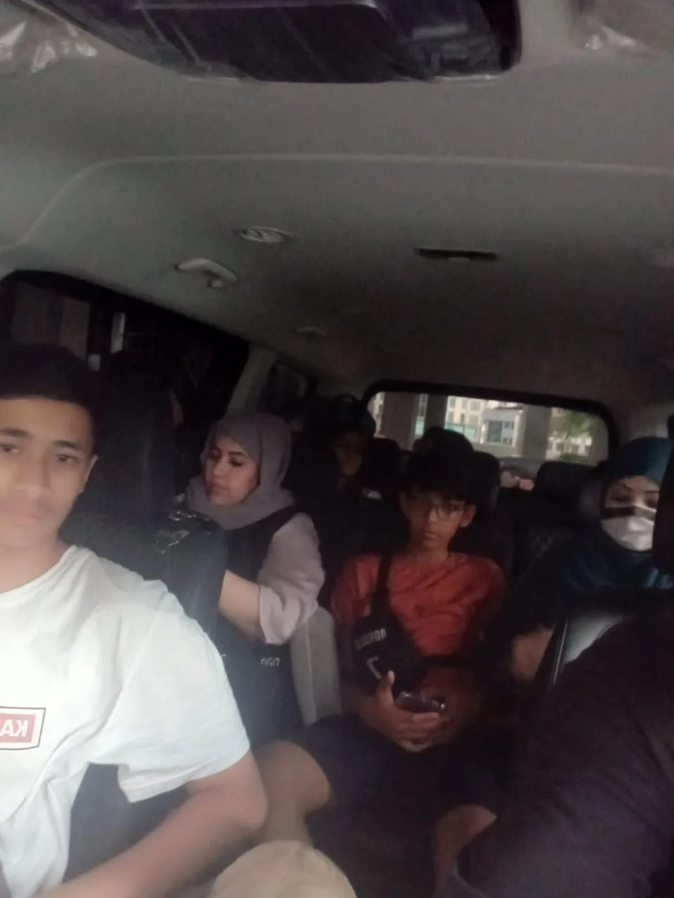 Group of young travellers in van during road trip